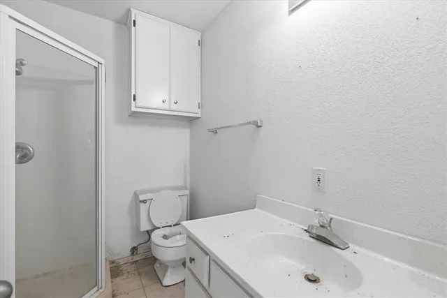 a bathroom with a sink a toilet and vanity