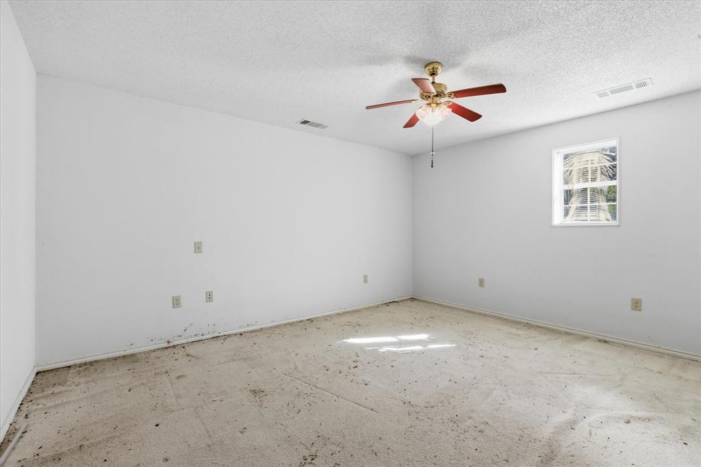 1708 Parker Road St. Paul, TX 75098 - Photo 15 of 31 an empty room with ceiling fan and window