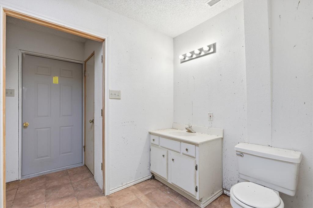 1708 Parker Road St. Paul, TX 75098 - Photo 16 of 31 a bathroom with a toilet a sink and mirror