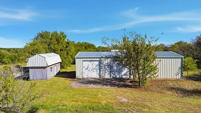 a view of a house with a yard and sitting area