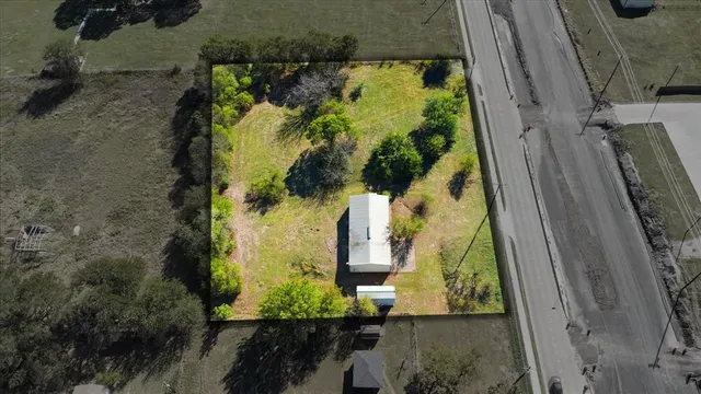 an aerial view of a residential house with outdoor space