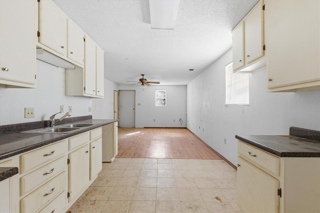 1708 Parker Road St. Paul, TX 75098 - Photo 10 of 31 a kitchen with granite countertop white cabinets and white appliances
