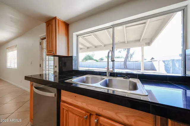 a kitchen sink sitting next to a window