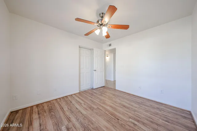 a view of an empty room with wooden floor