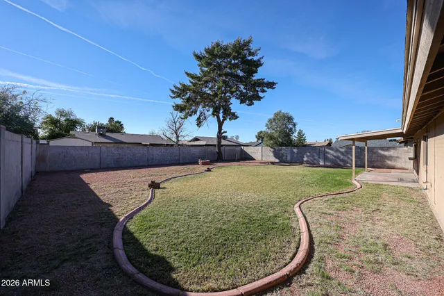 a view of a swimming pool with a yard