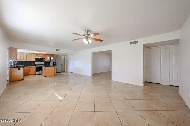 a view of a kitchen with furniture and an empty room