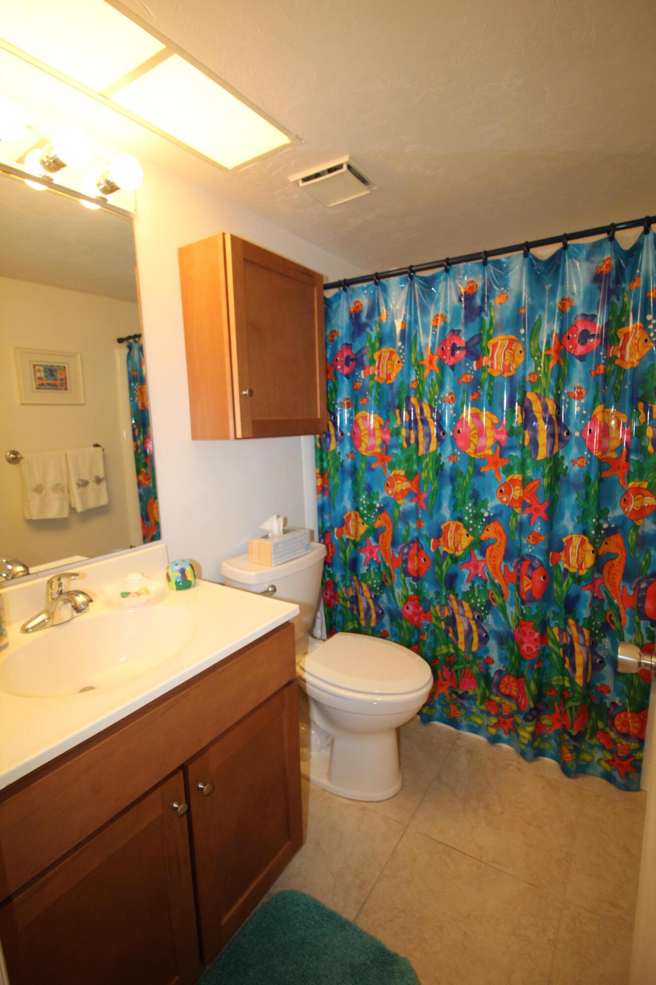 1024 Manatee Naples, Unit C301 Naples, FL 34114 - Photo 12 of 23 a bathroom with a sink mirror vanity and toilet