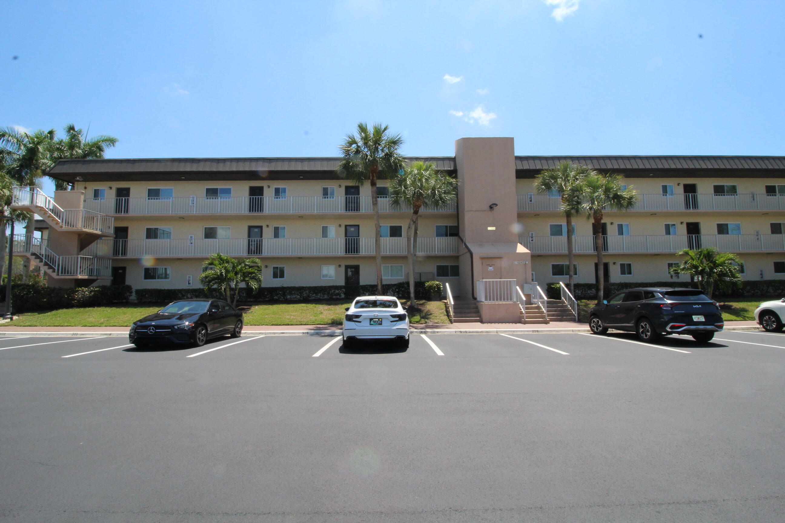 1024 Manatee Naples, Unit C301 Naples, FL 34114 - Photo 15 of 23 a car parked in front of a building