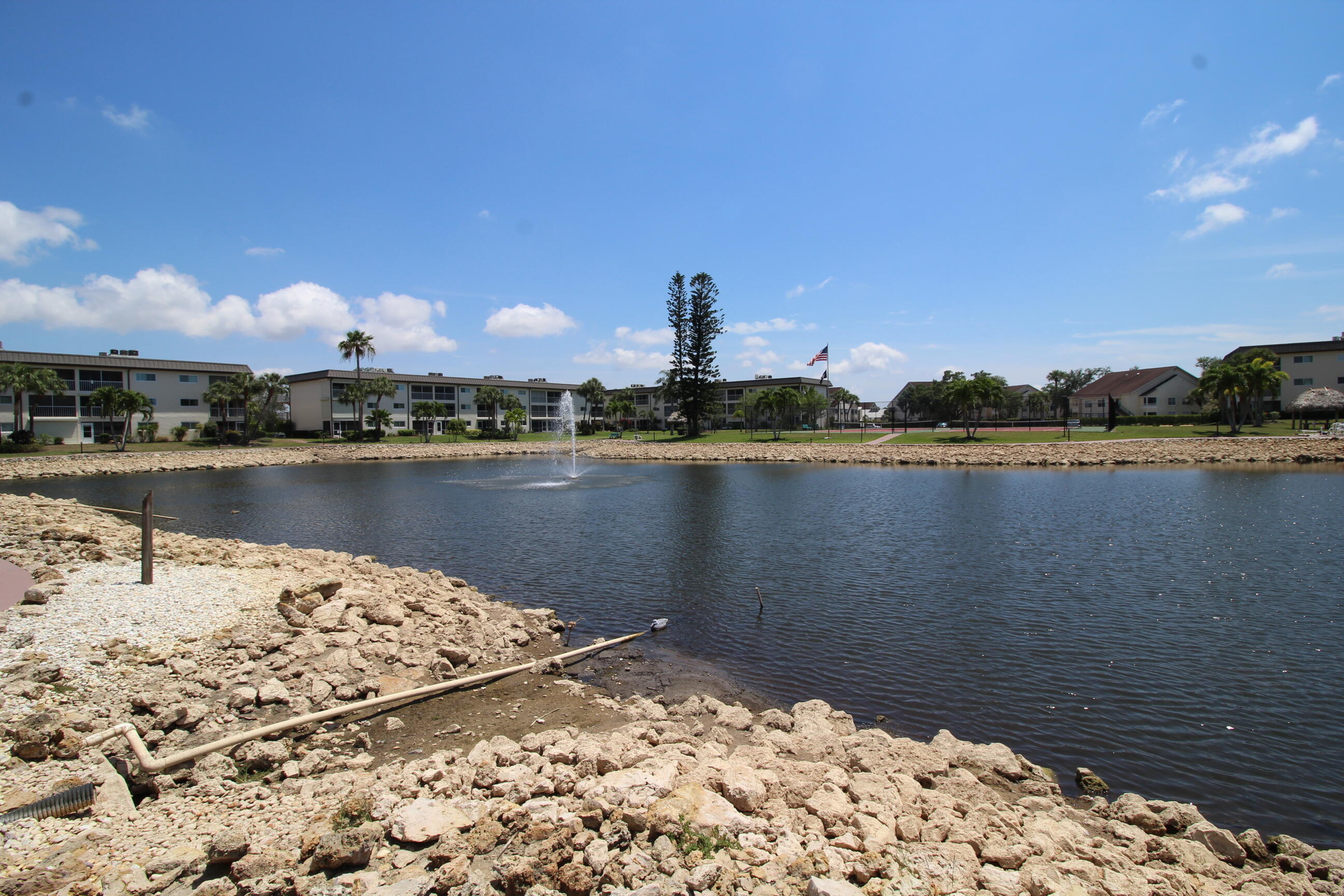 1024 Manatee Naples, Unit C301 Naples, FL 34114 - Photo 16 of 23 a view of a lake with a building in the background