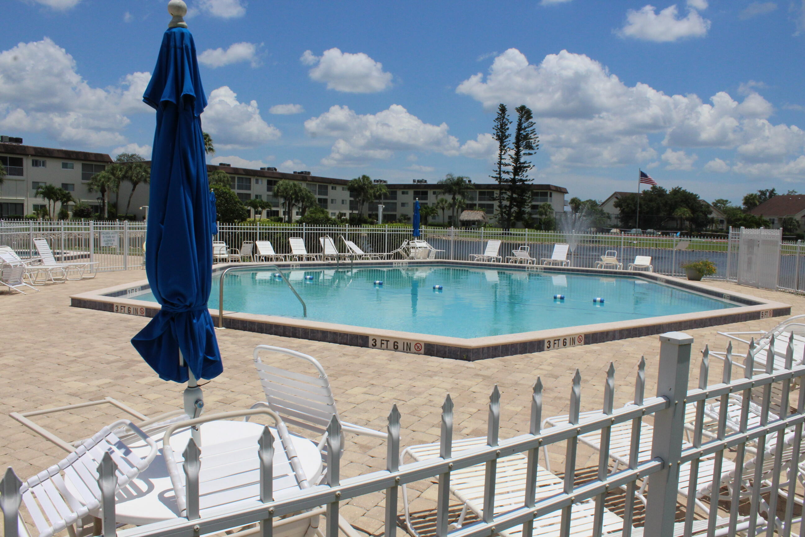 1024 Manatee Naples, Unit C301 Naples, FL 34114 - Photo 18 of 23 a view of a swimming pool with a deck