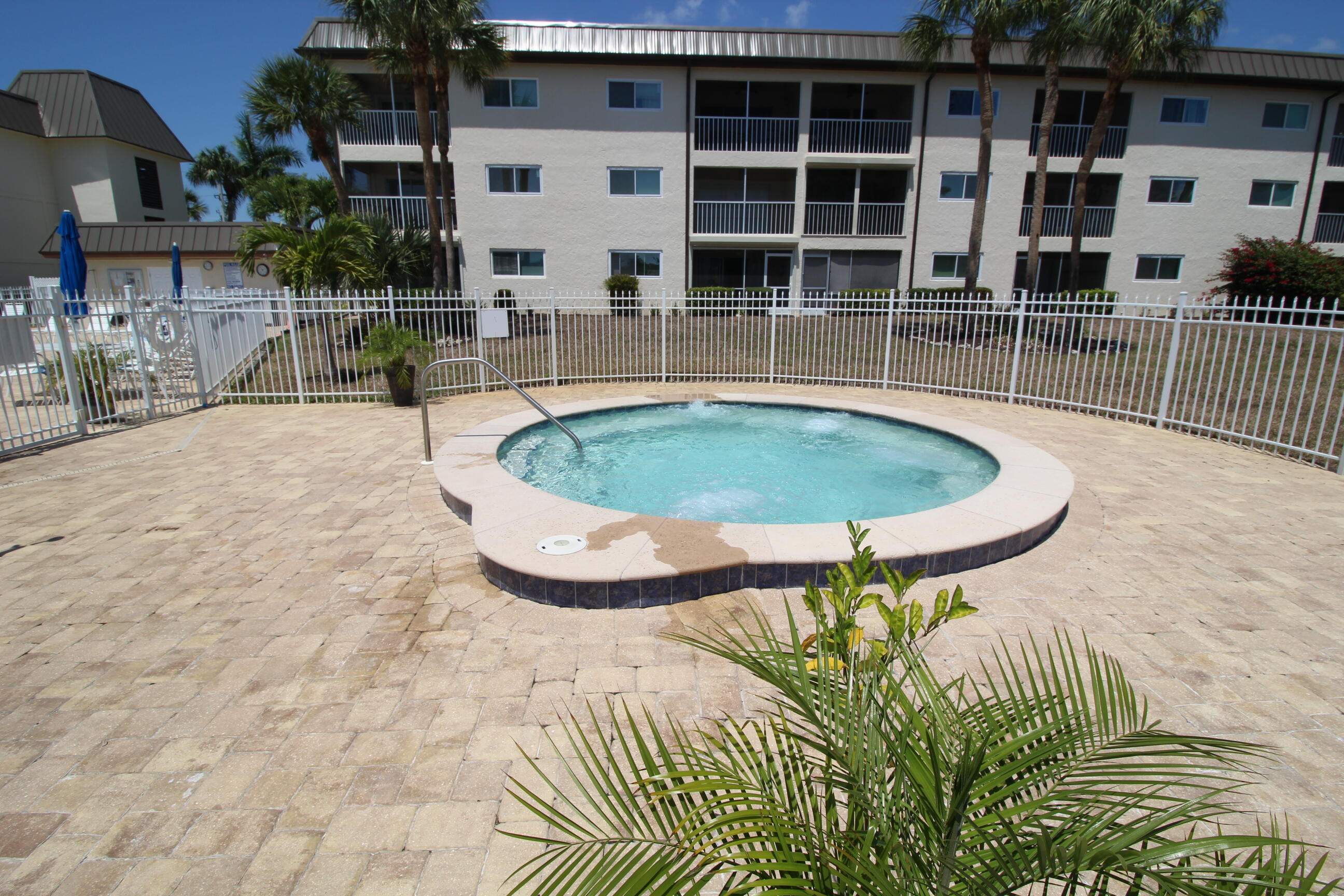 1024 Manatee Naples, Unit C301 Naples, FL 34114 - Photo 19 of 23 a view of a swimming pool with a patio