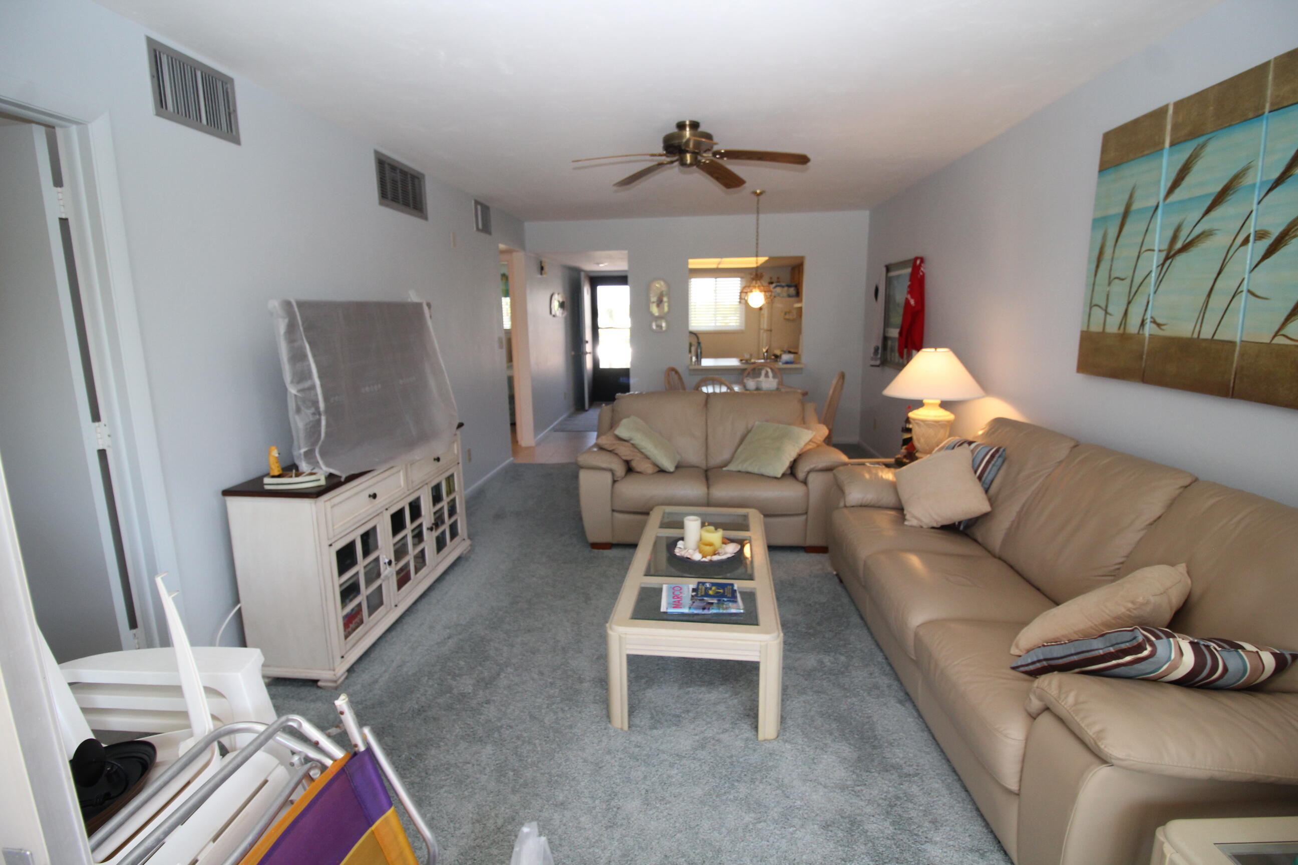 1024 Manatee Naples, Unit C301 Naples, FL 34114 - Photo 2 of 23 a living room with furniture and a flat screen tv