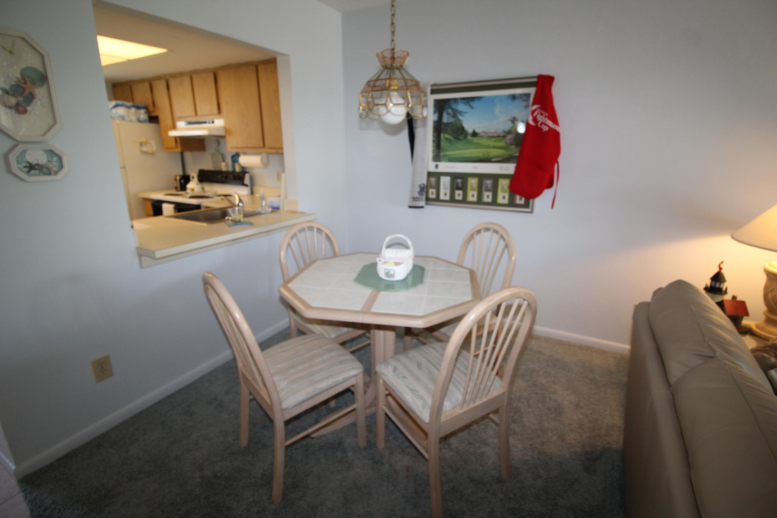 1024 Manatee Naples, Unit C301 Naples, FL 34114 - Photo 5 of 23 a dining room with furniture and window