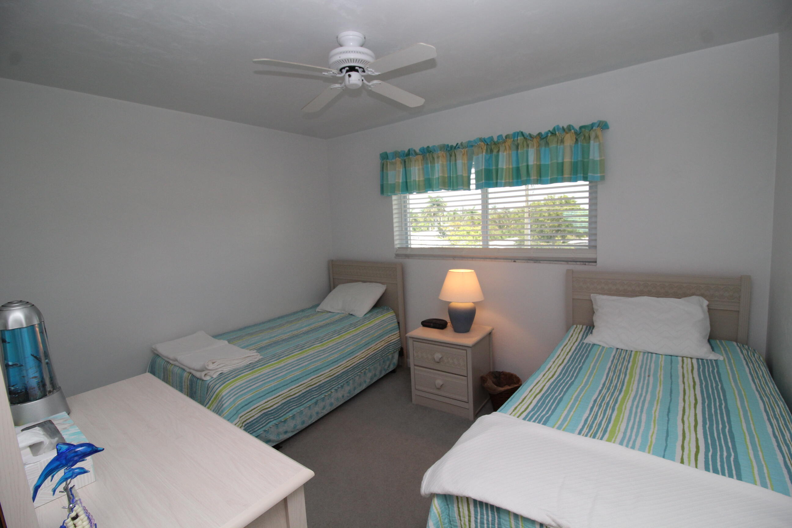 1024 Manatee Naples, Unit C301 Naples, FL 34114 - Photo 10 of 23 a bedroom with two beds and a table