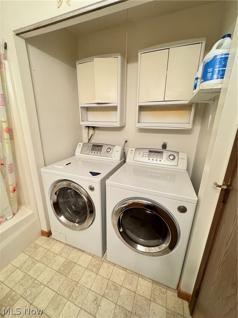 1763 Aberdeen Road Madison, OH 44057 - Photo 26 of 31 Washroom with cabinets, light tile floors, and washer and clothes dryer