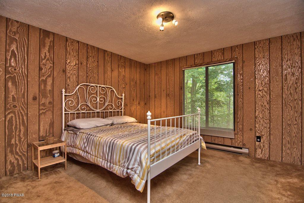 3278 Northgate Road Lake Ariel, PA 18436 - Photo 28 of 40 a bed sitting in a spacious bedroom next to a window