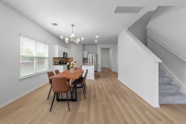 a dining room with furniture and wooden floor