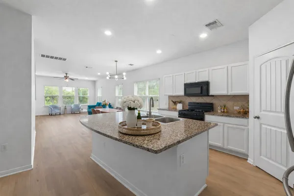 a kitchen with a sink stove and refrigerator