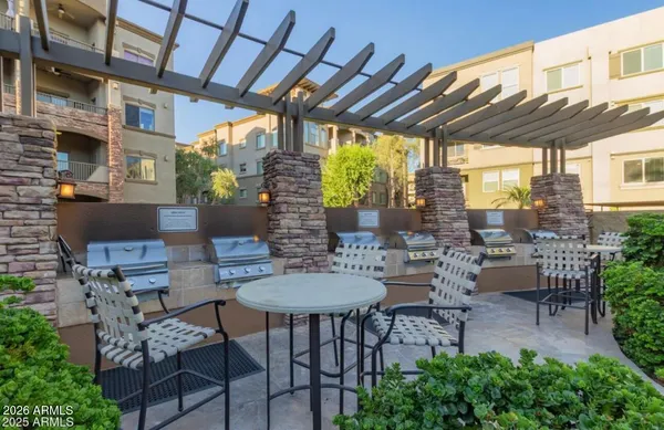 a view of a patio with a table and chairs and potted plants