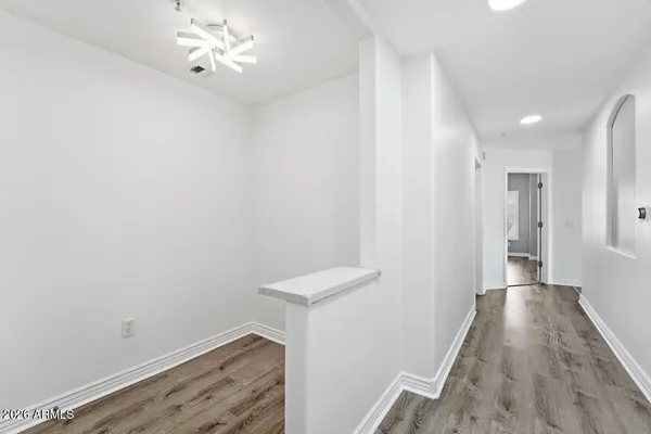 a view of a hallway with wooden floor