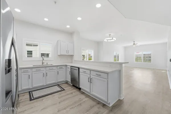 a large kitchen with kitchen island a sink stainless steel appliances and cabinets
