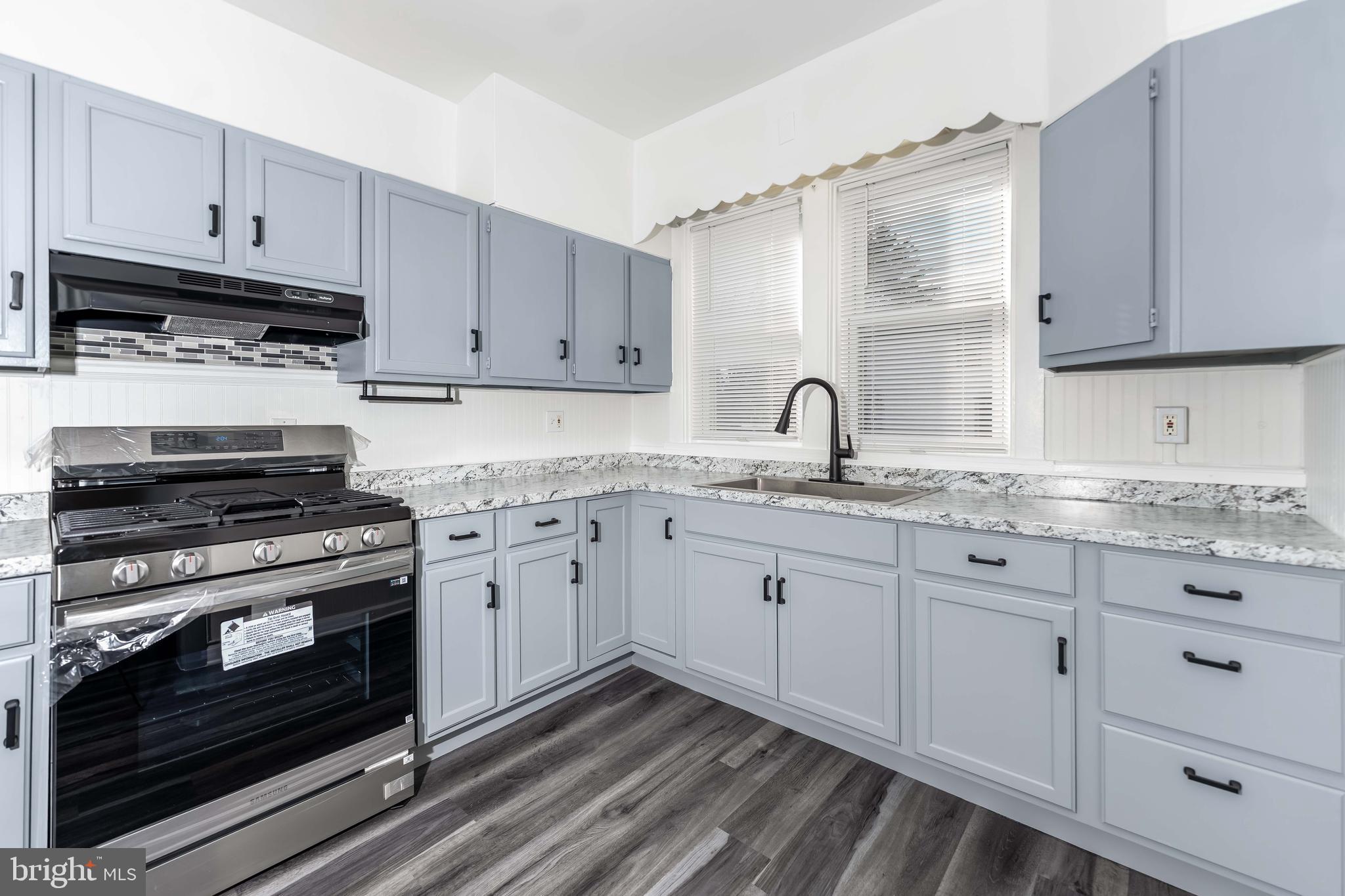 2500 Derry Street Harrisburg, PA 17111 - Photo 5 of 30 a kitchen with granite countertop a stove sink and cabinets