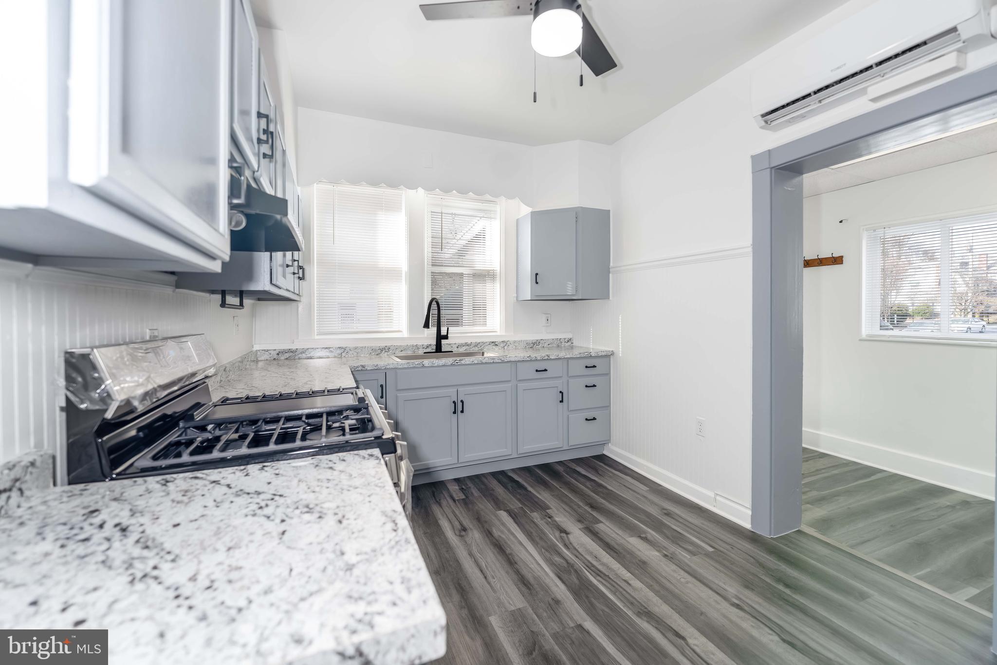 2500 Derry Street Harrisburg, PA 17111 - Photo 6 of 30 a kitchen with stainless steel appliances a stove a sink cabinets and a wooden floor