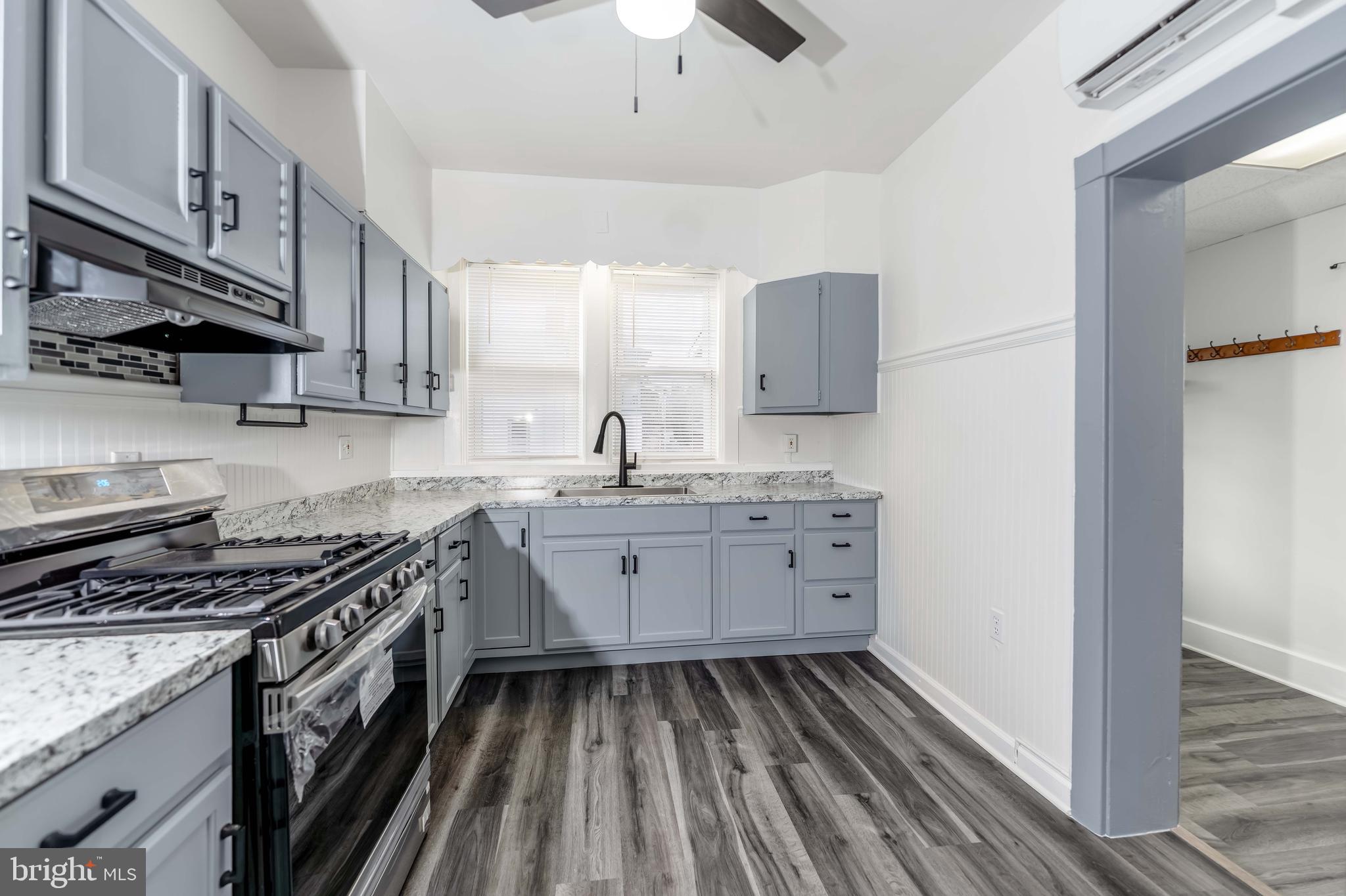 2500 Derry Street Harrisburg, PA 17111 - Photo 7 of 30 a kitchen with granite countertop a sink stove and cabinets