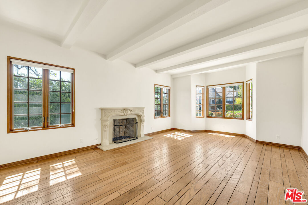 3274 Hutton Drive Beverly Hills, CA 90210 - Photo 11 of 23 a view of an empty room with a window and wooden floor