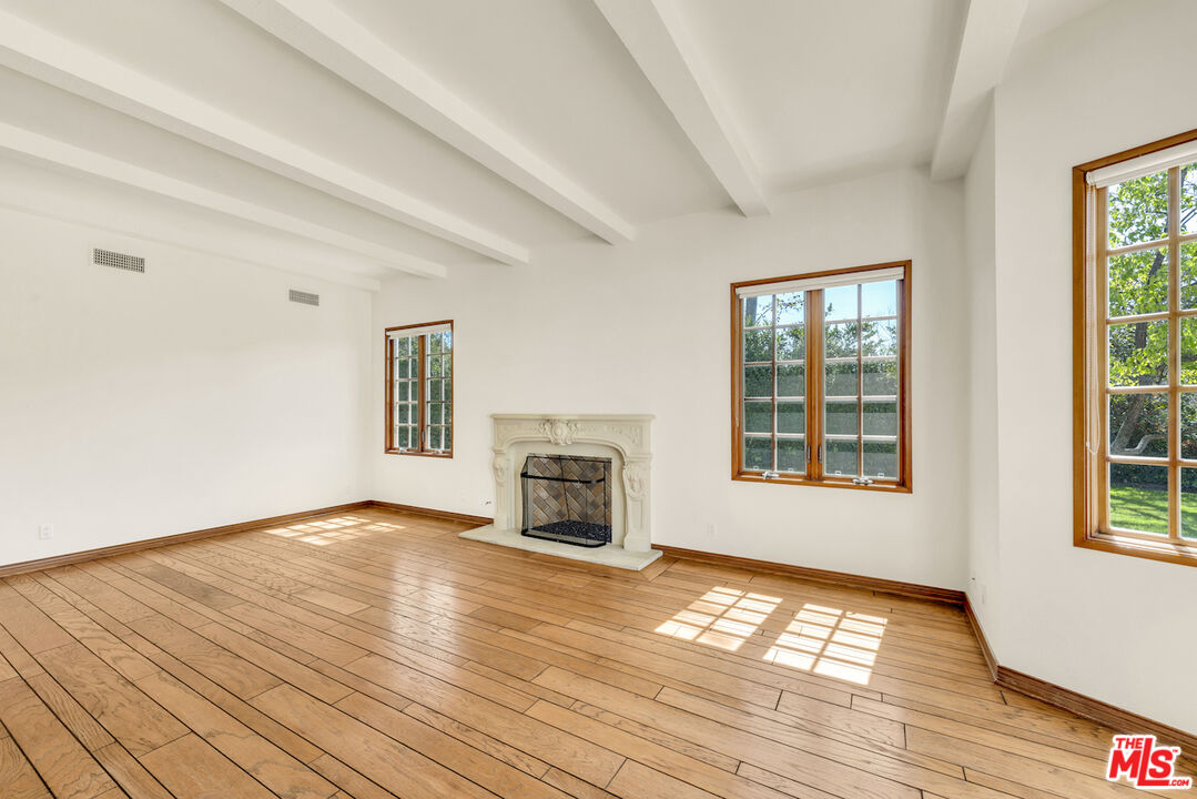 3274 Hutton Drive Beverly Hills, CA 90210 - Photo 12 of 23 a view of empty room with wooden floor and fireplace