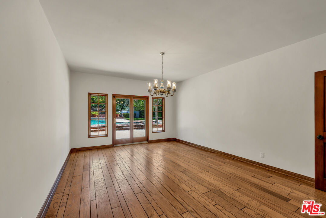 3274 Hutton Drive Beverly Hills, CA 90210 - Photo 9 of 23 a view of an empty room with wooden floor and a window