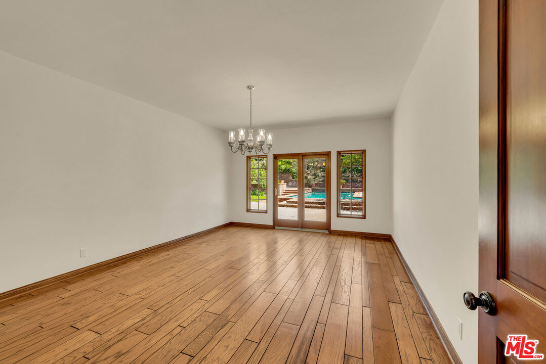 3274 Hutton Drive Beverly Hills, CA 90210 - Photo 10 of 23 wooden floor in an empty room with a window