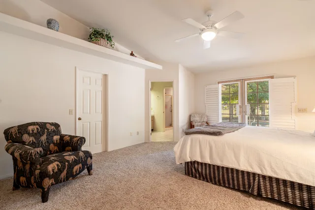 a bedroom with a bed couch and window