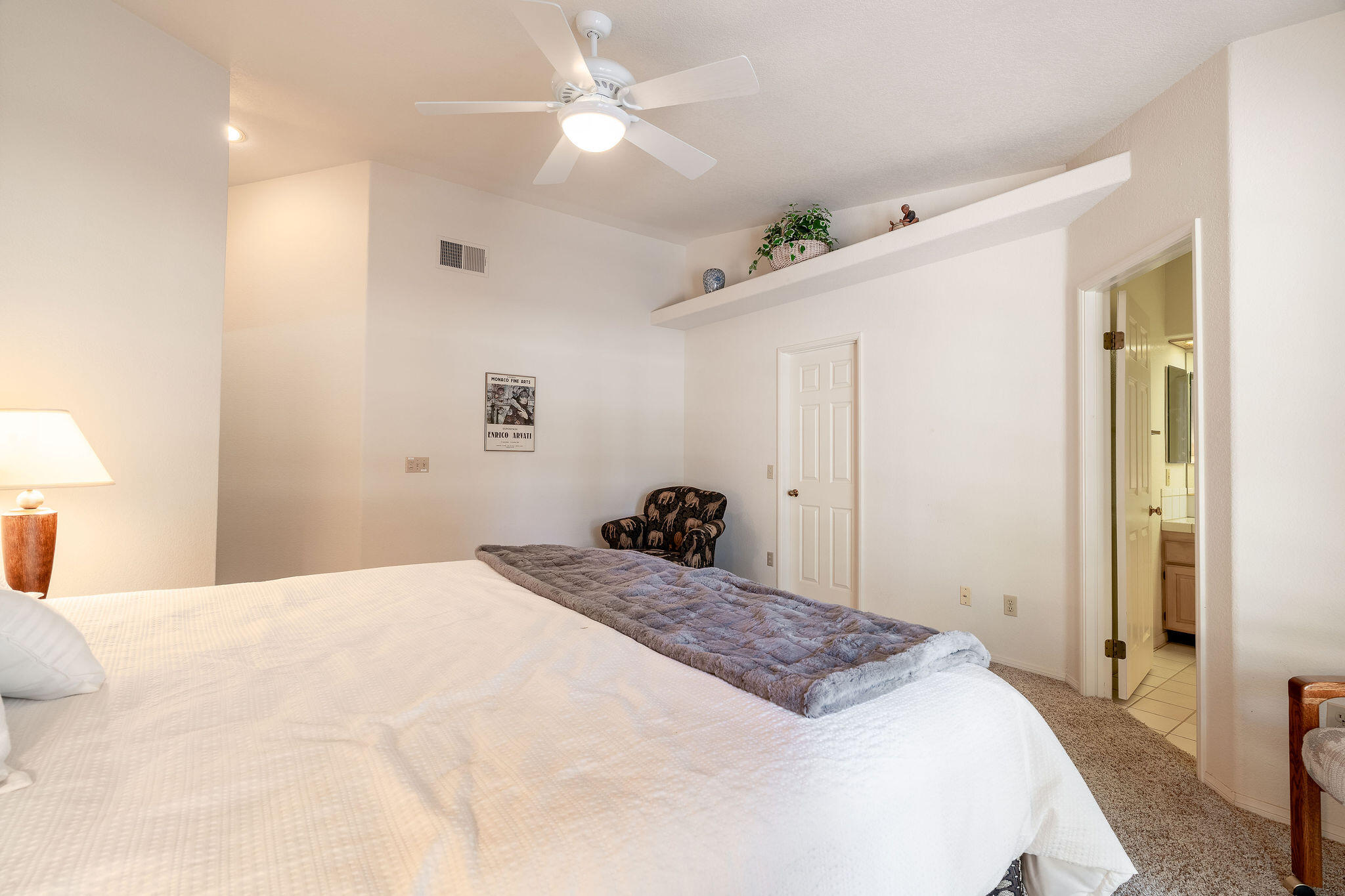 82151 Hanson Drive Indio, CA 92201 - Photo 17 of 38 a bedroom with a bed and a chandelier