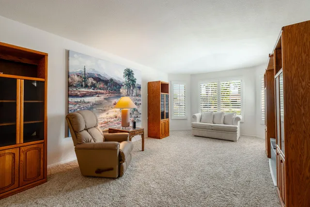 a living room with furniture and a floor to ceiling window