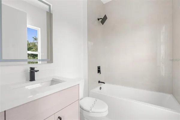 a bathroom with a sink toilet and bathtub