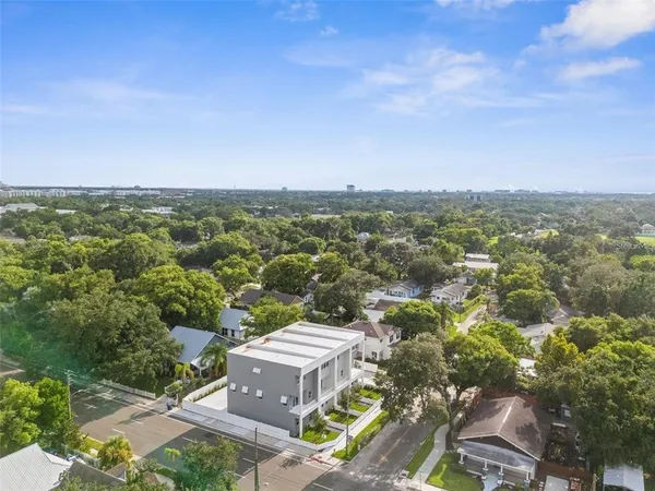 an aerial view of a house with a yard