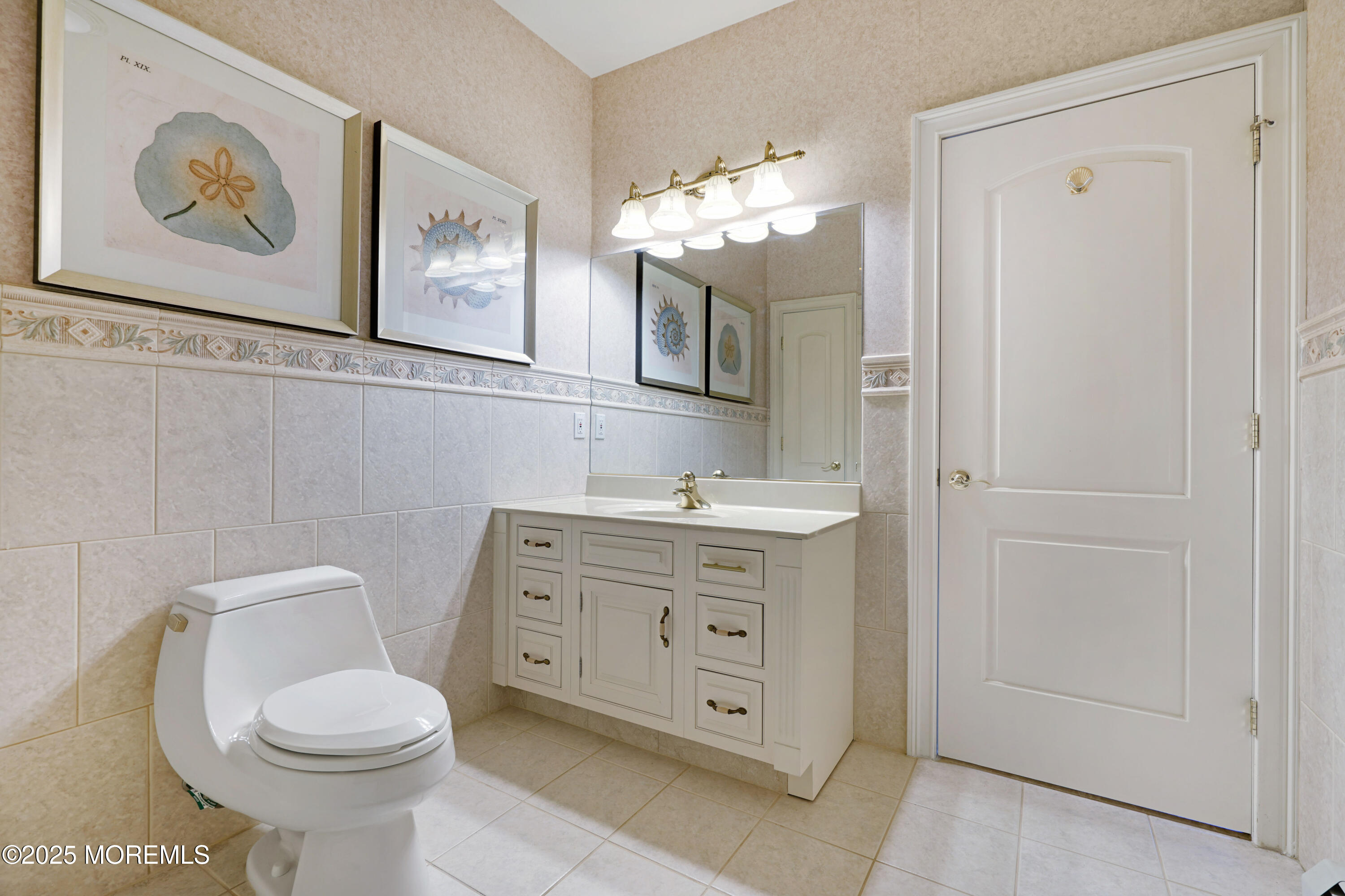 233 Beach Front, Unit 3 Manasquan, NJ 08736 - Photo 1 of 18 a bathroom with a toilet sink and mirror