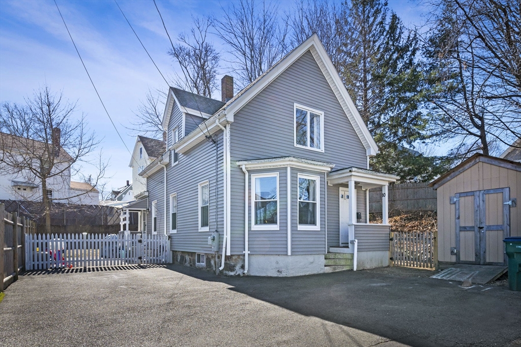 a view of a house with a large tree