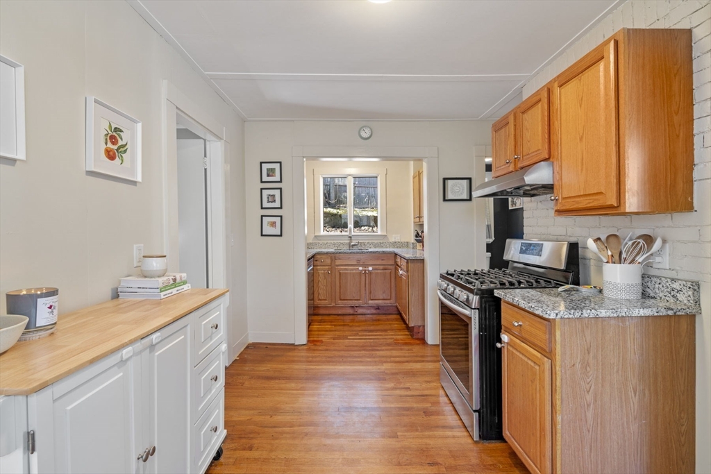 10 Stoddard Terrace Lynn, MA 01902 - Photo 8 of 40 a kitchen with stainless steel appliances granite countertop a sink stove and refrigerator