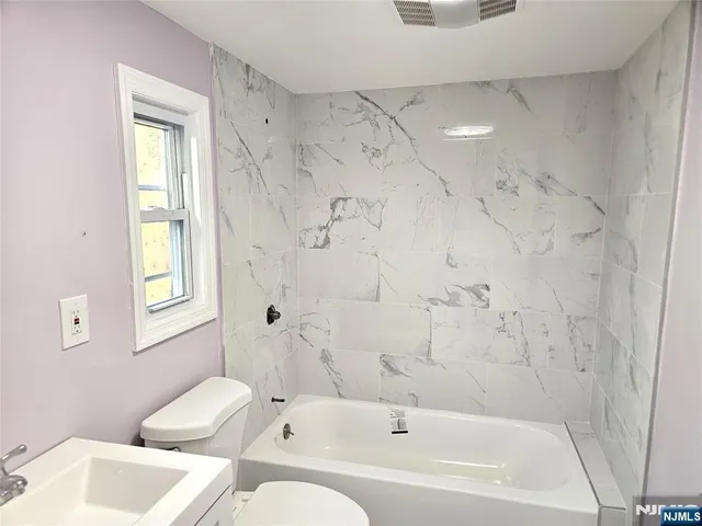 a bathroom with a bathtub toilet and sink