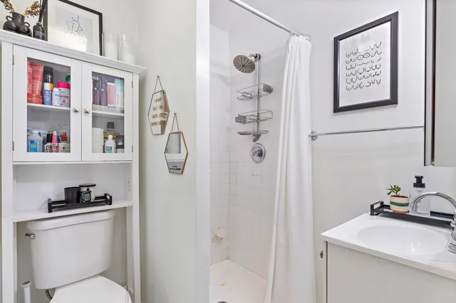 a bathroom with a toilet sink and shower