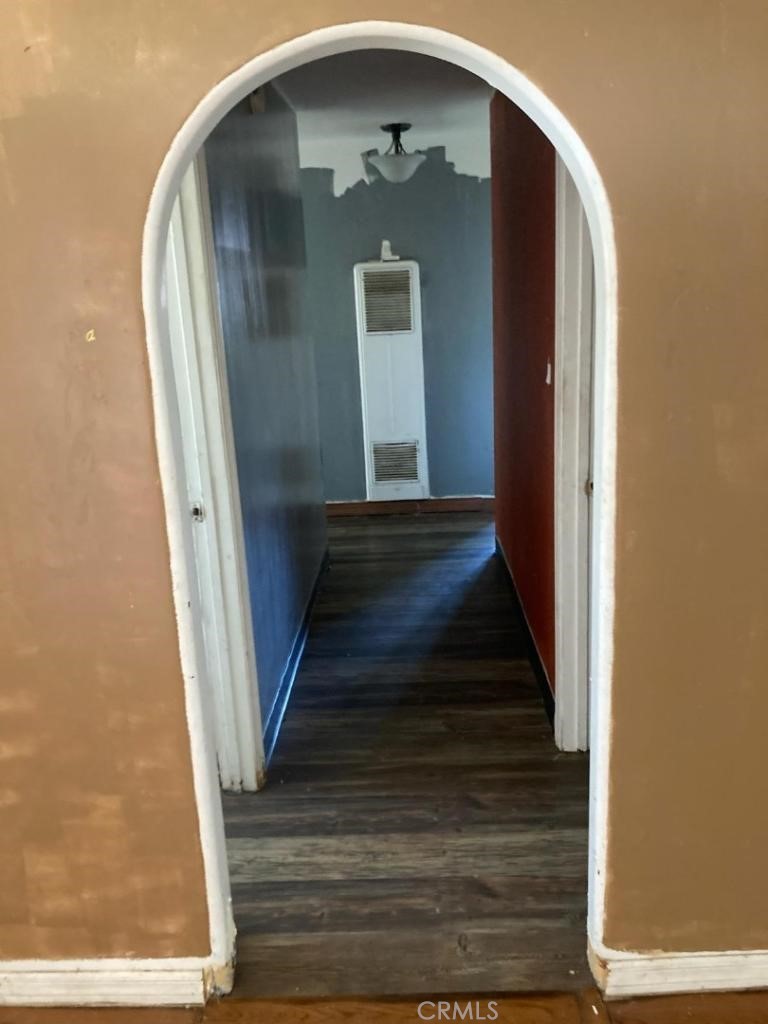 a view of a hallway with wooden floor and entryway