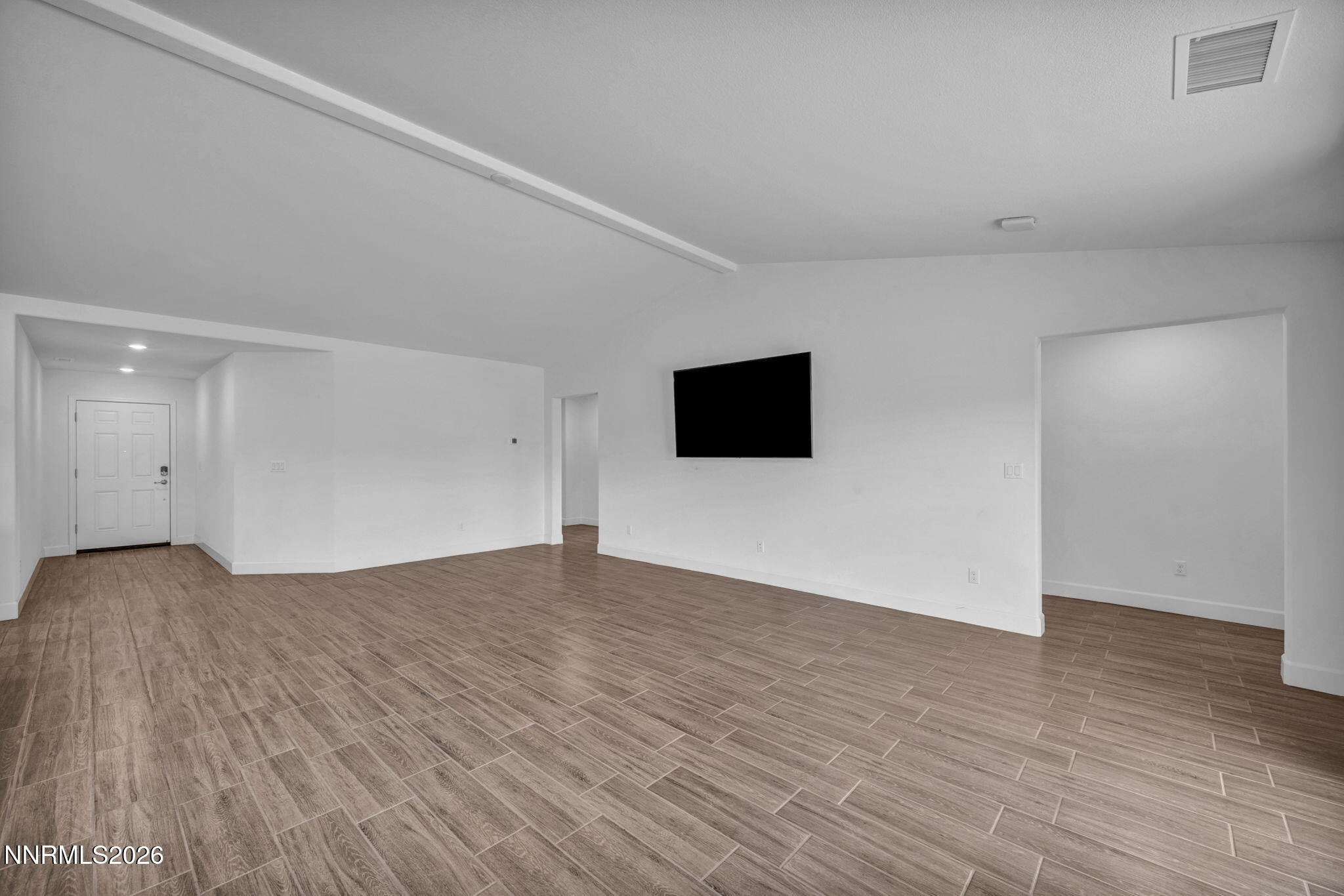 7181 Saddlehorn Road Carson City, NV 89701 - Photo 8 of 62 a view of an empty room with wooden floor and windows