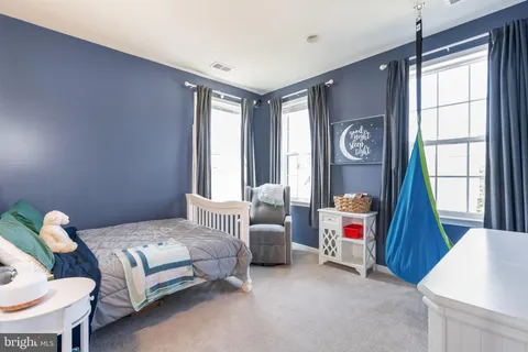 a bedroom with furniture and a large window