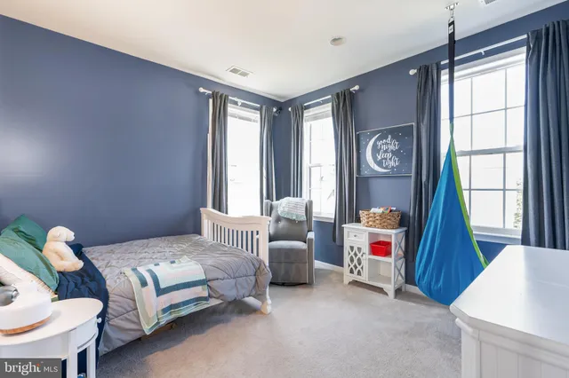 a bedroom with furniture and a large window