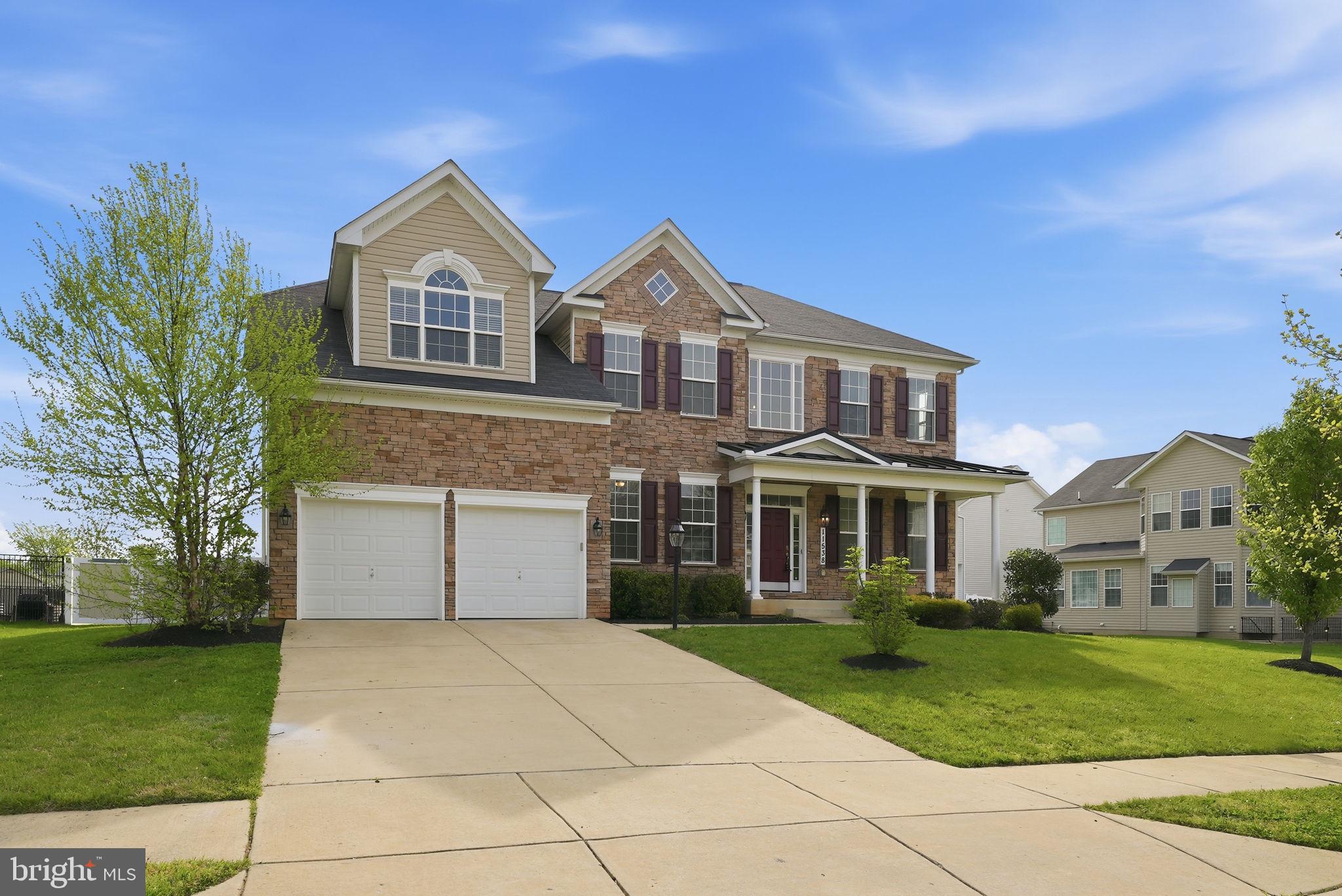 11538 Neon Road Fort Washington, MD 20744 - Photo 2 of 58 a front view of a house with a yard and garage