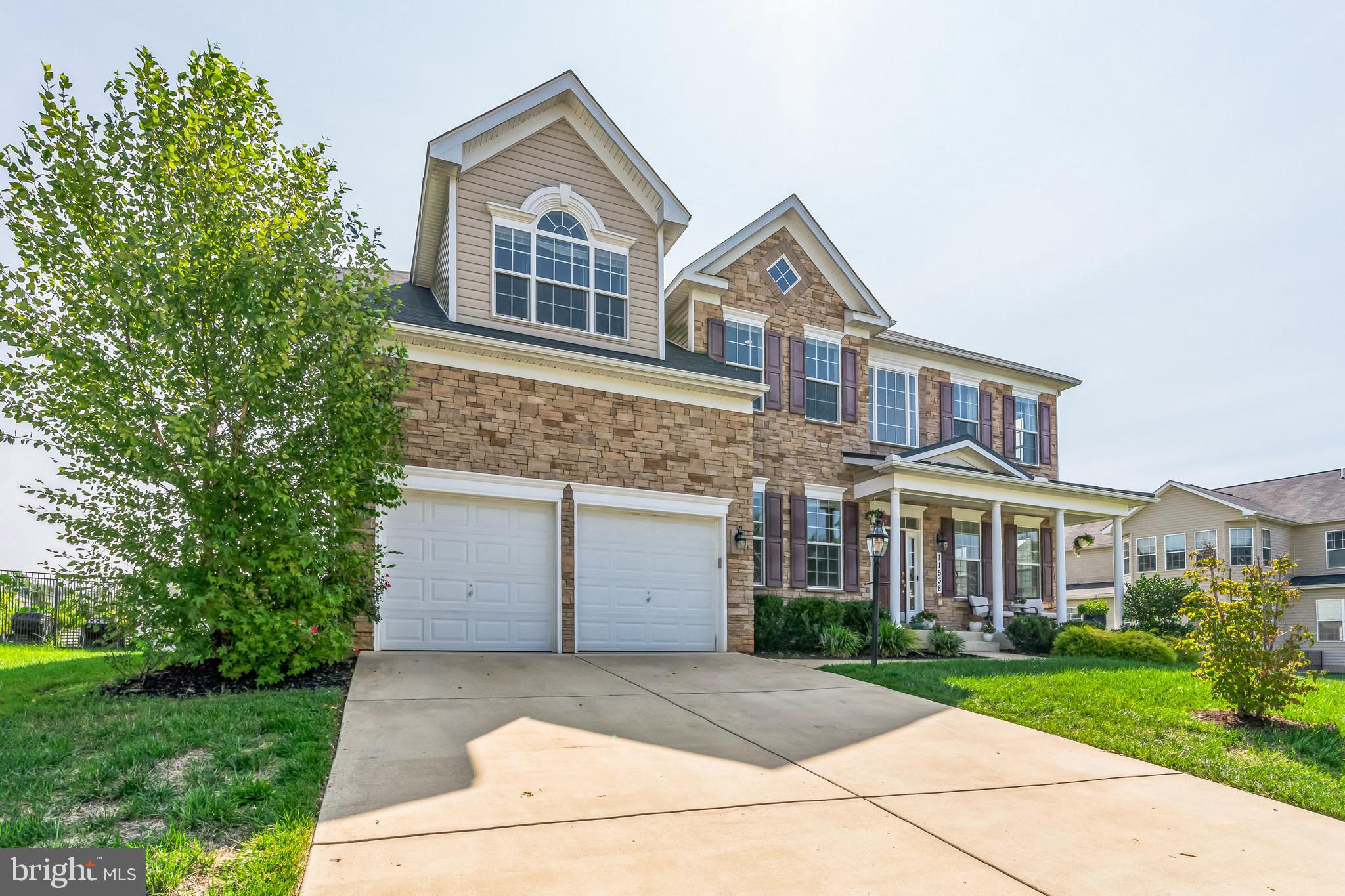11538 Neon Road Fort Washington, MD 20744 - Photo 2 of 50 a front view of a house with a yard and garage