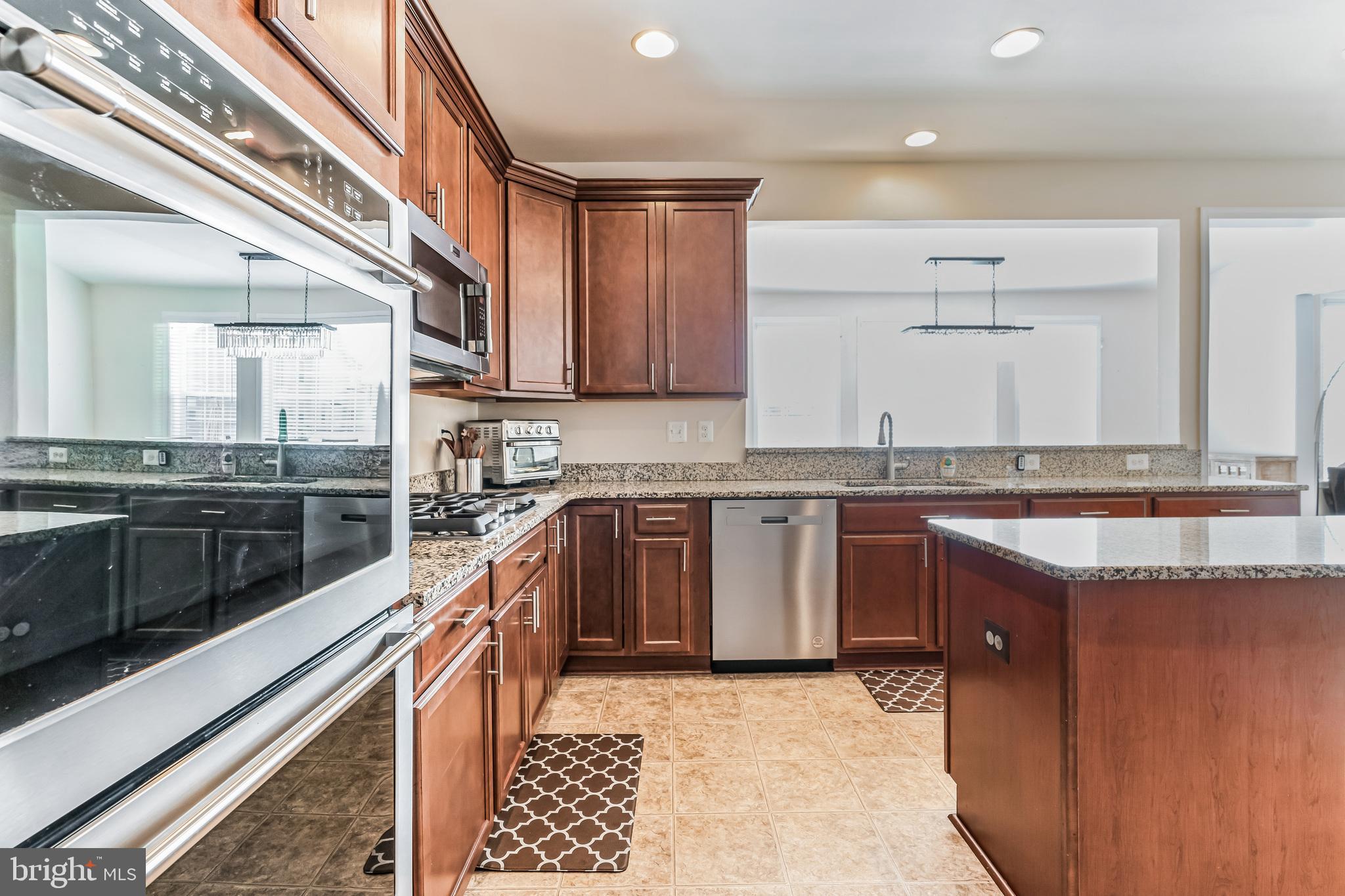 11538 Neon Road Fort Washington, MD 20744 - Photo 26 of 50 a kitchen with granite countertop a sink stove and cabinets