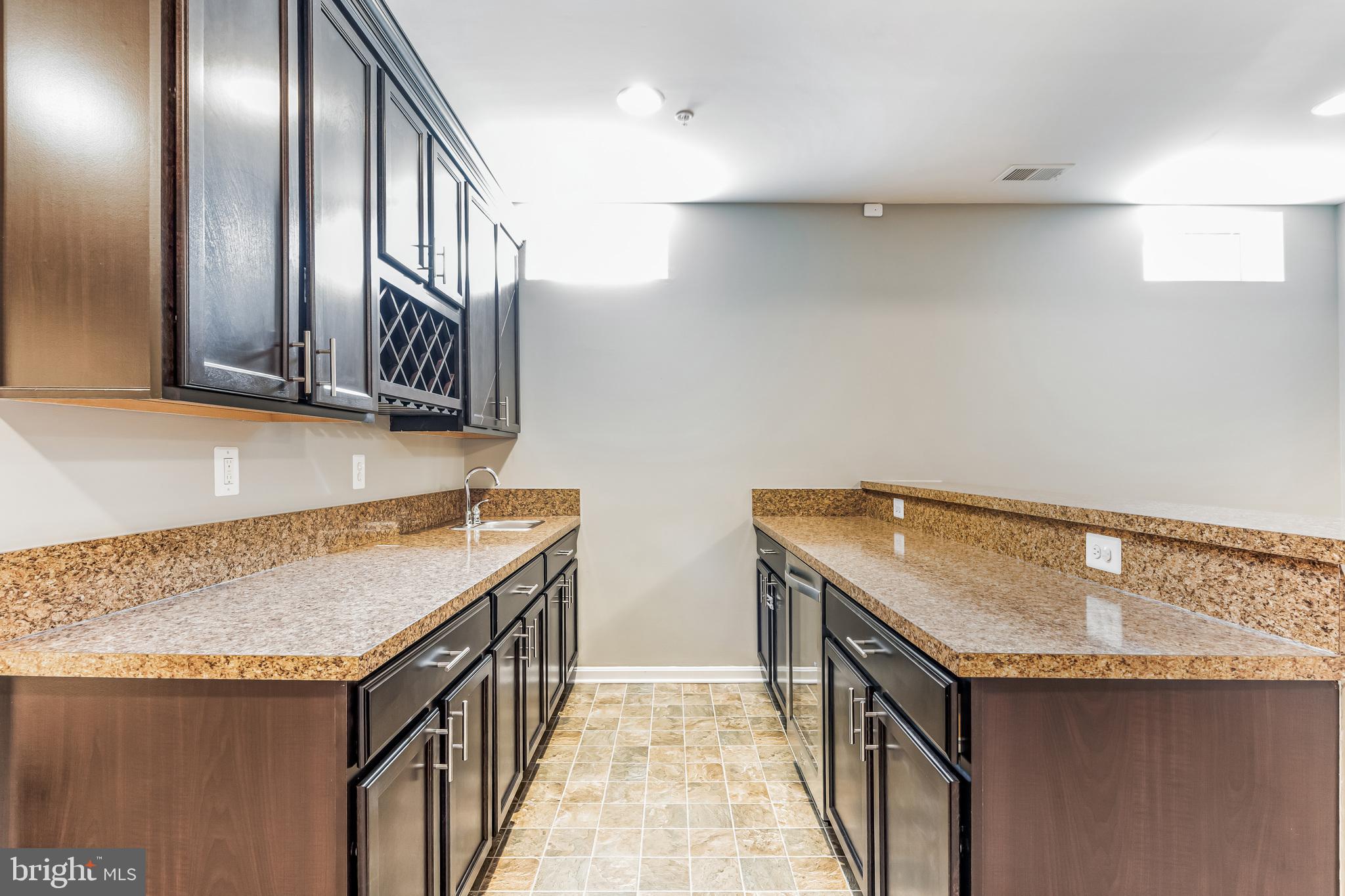 11538 Neon Road Fort Washington, MD 20744 - Photo 31 of 50 a kitchen with stainless steel appliances granite countertop a sink and a wooden cabinets